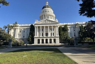 The California state capitol building surrounded by grass and trees